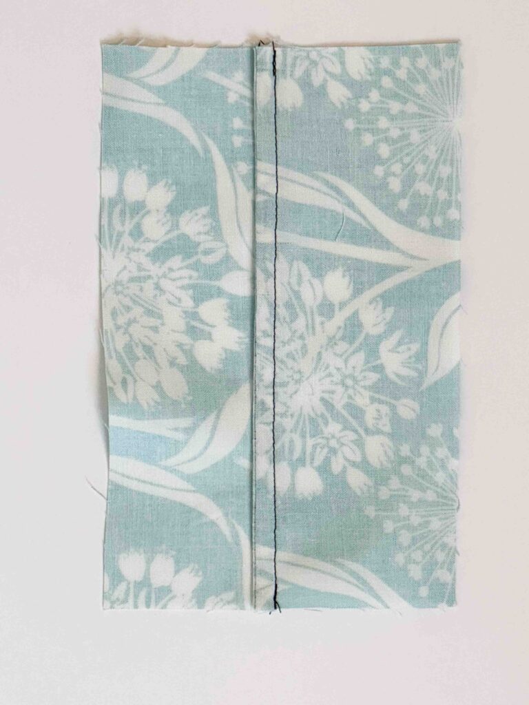 blue floral fabric shown with a french seam displayed
